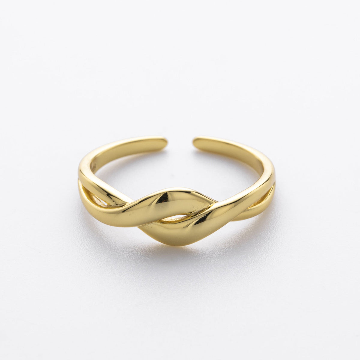 Gold-plated silver wave ring on a white background