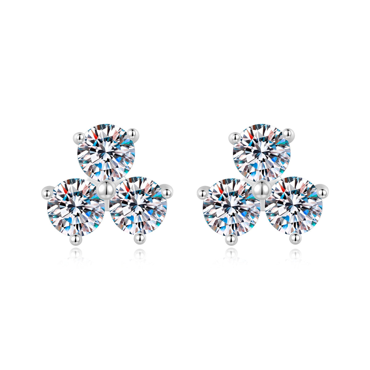 Silver three-stone moissanite stud earrings on a white background