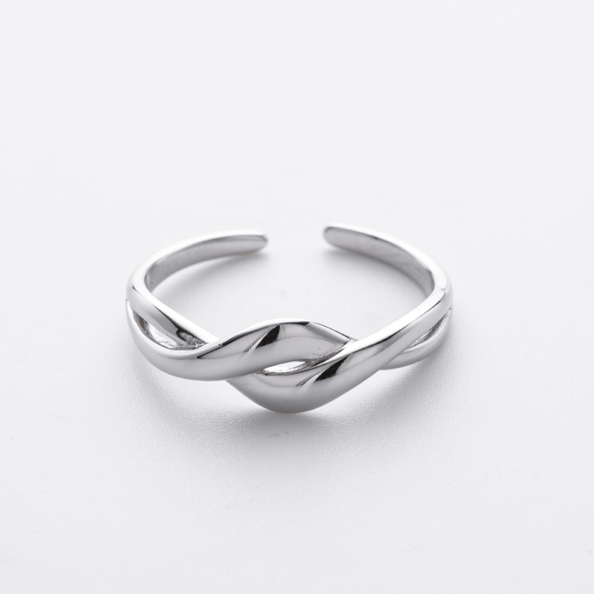 Plain silver wave ring on a white background