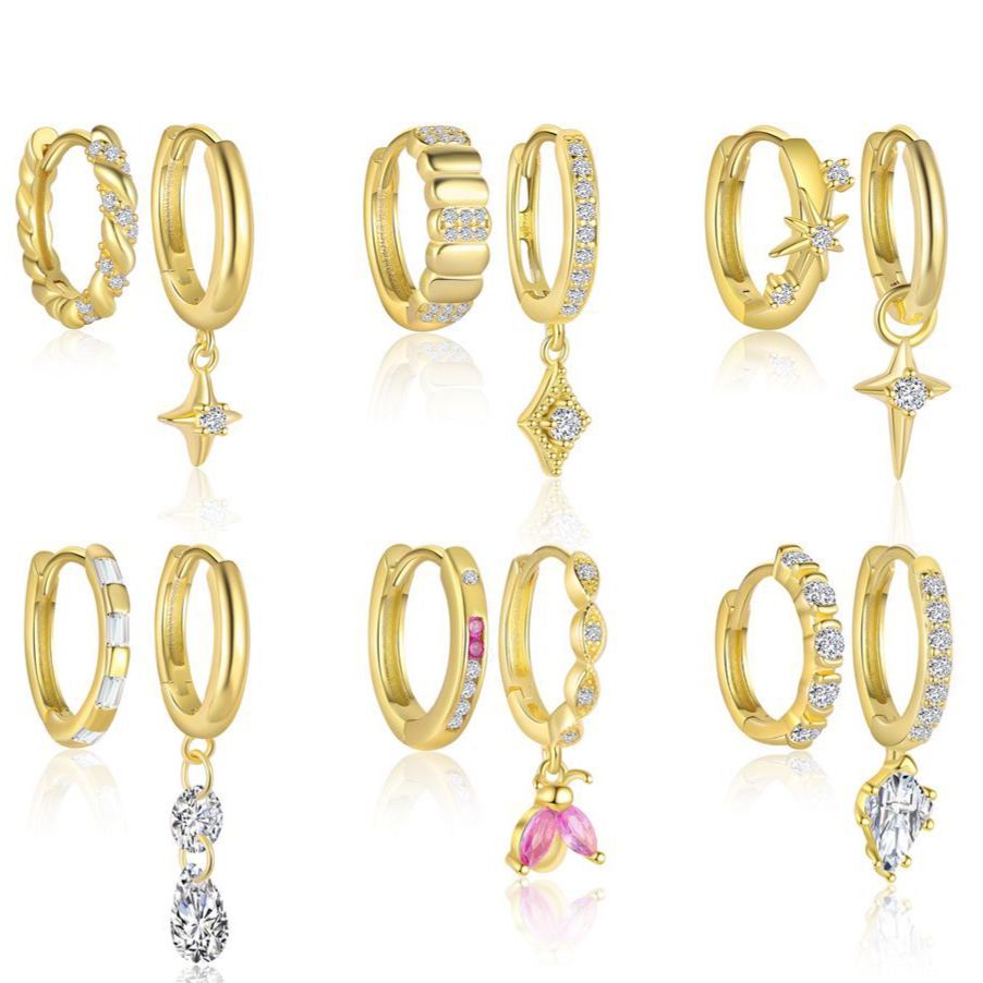 Gold-plated silver huggie earrings with zirconia on a white background
